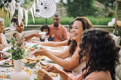 Cheerful family in dinner party at backyard