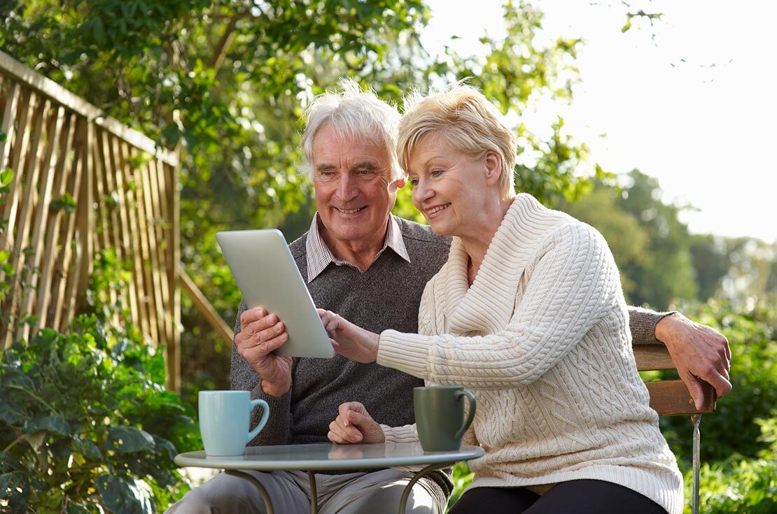 retired couple reviewing financial plan on tablet